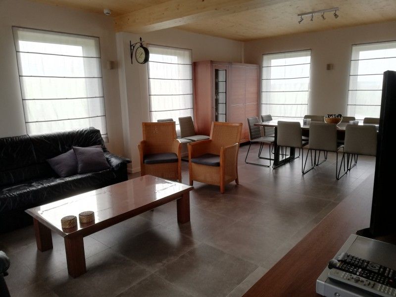 Cozy living room and dining area in Maison de l'amitie, vacation home in the Ardennes, Houffalize, ideal for family stays.