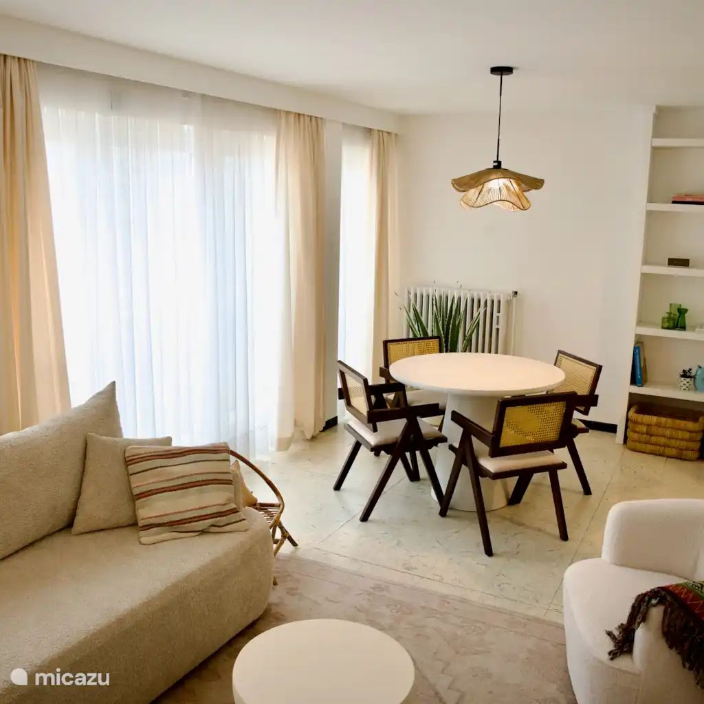 Stylish interior of the Let's Go Koksijde apartment on the Belgian coast, featuring a cozy dining area and plenty of natural light.