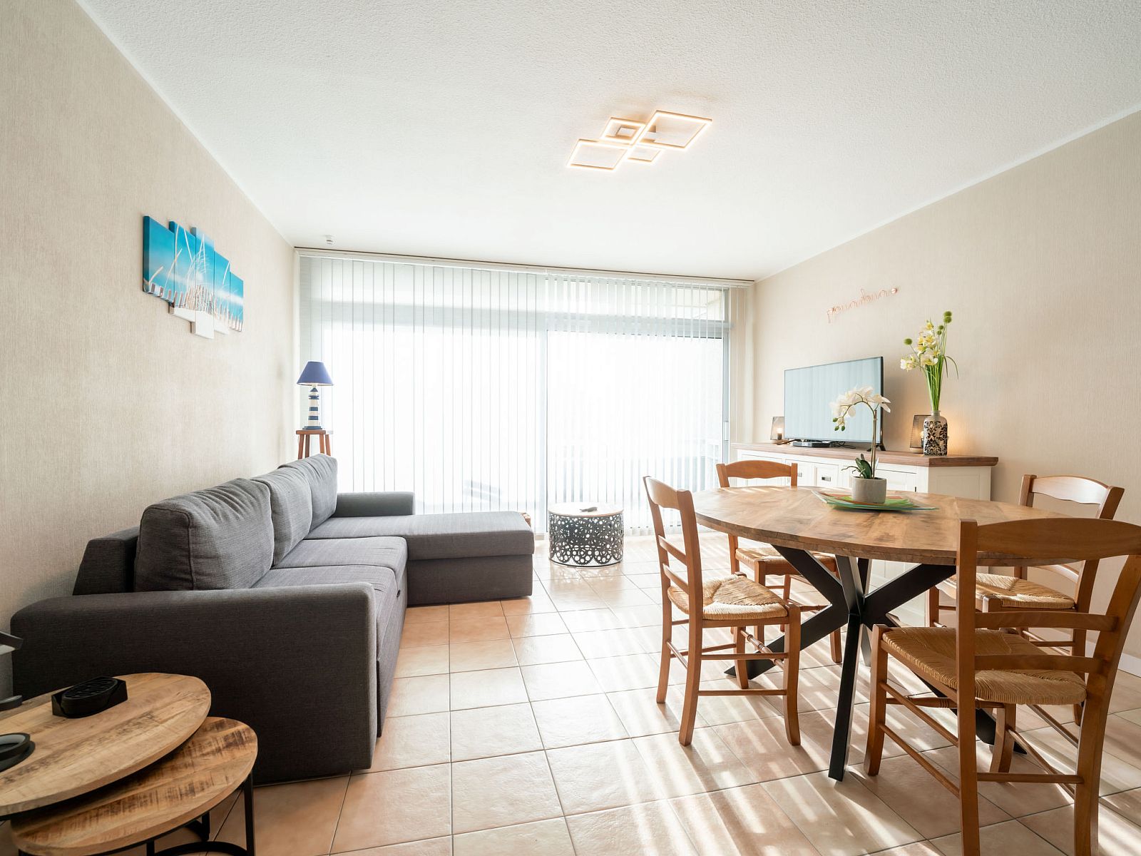 Cozy living room of Apartment Astrid 62/101 in Bredene, Belgian coast, with comfortable sitting area and dining area for a relaxing stay.
