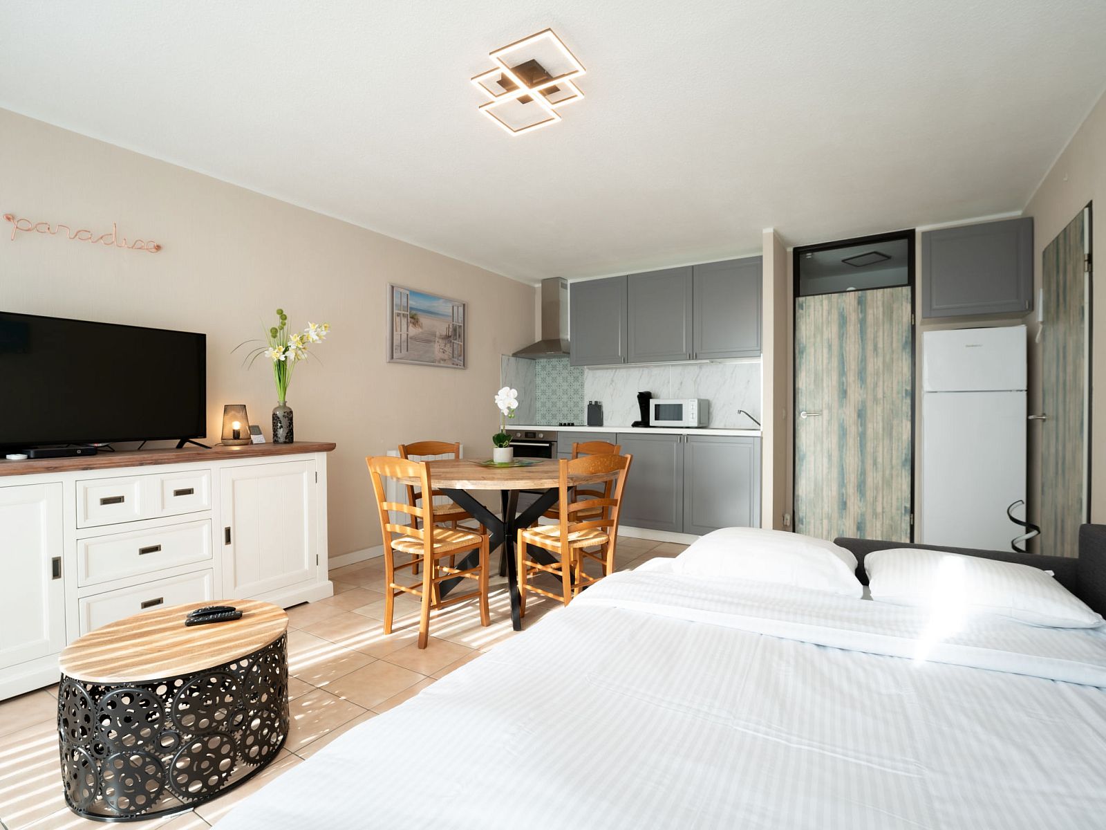 Bright interior space of Apartment Astrid 62/101 in Bredene, Belgian coast, with modern kitchen and cozy dining area.
