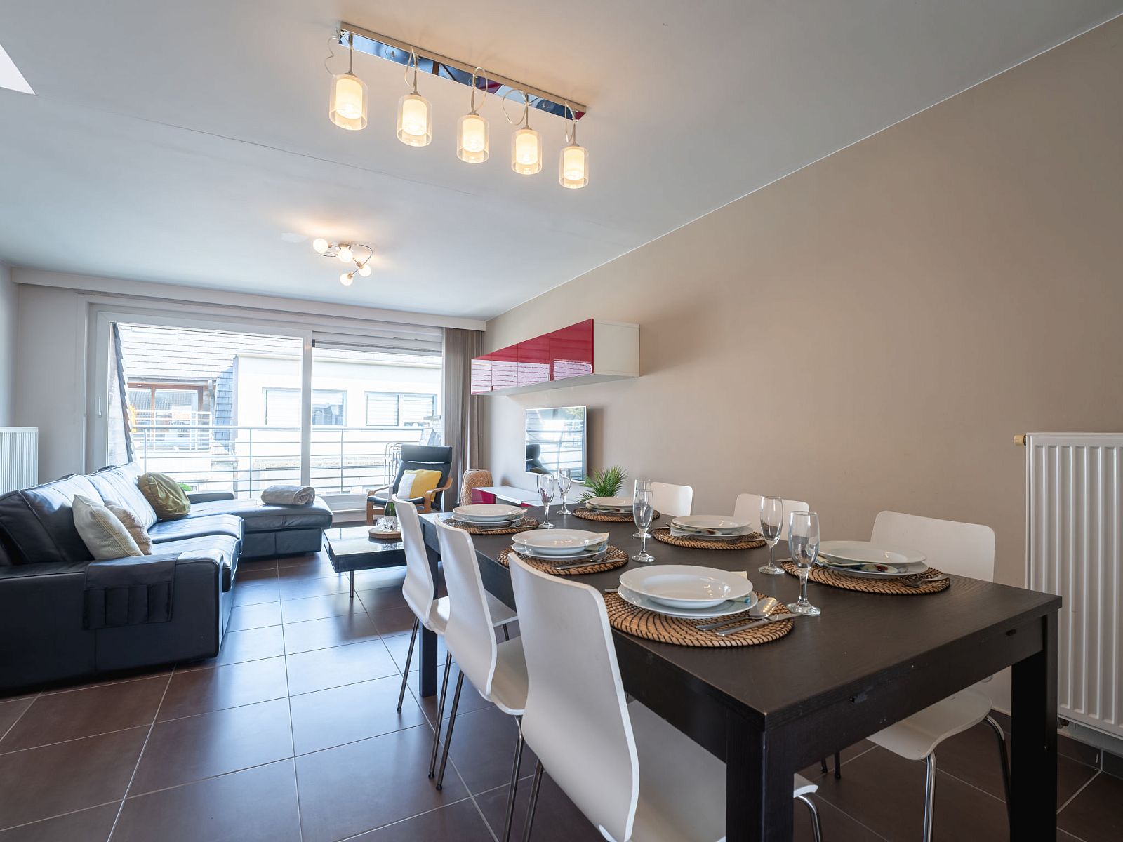Cozy dining and living room in Apartment Ter Duyne, Bredene, Belgian coast, ideal vacation accommodation with modern interior and balcony.