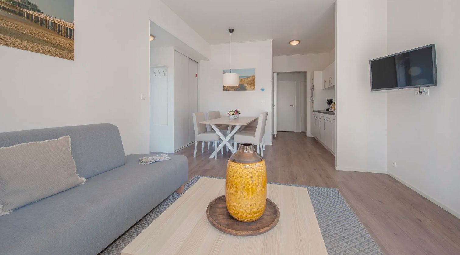 Cozy living room in Chalet in Bredene, Belgian coast, with modern decor and bright dining area for a relaxing vacation stay.