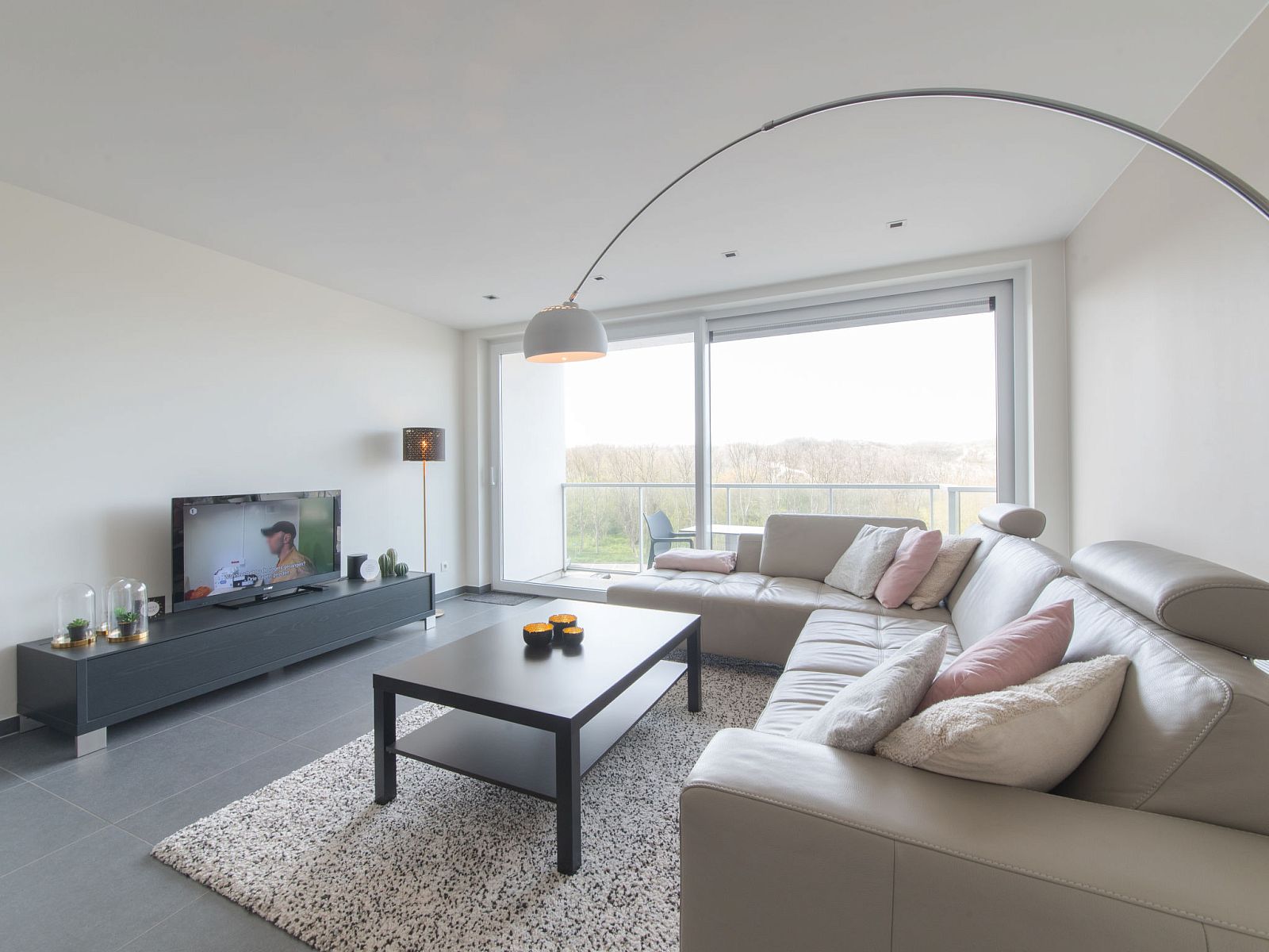 Cozy living room of Apartment Solis in Bredene, Belgian coast, with modern decor and views of nature.