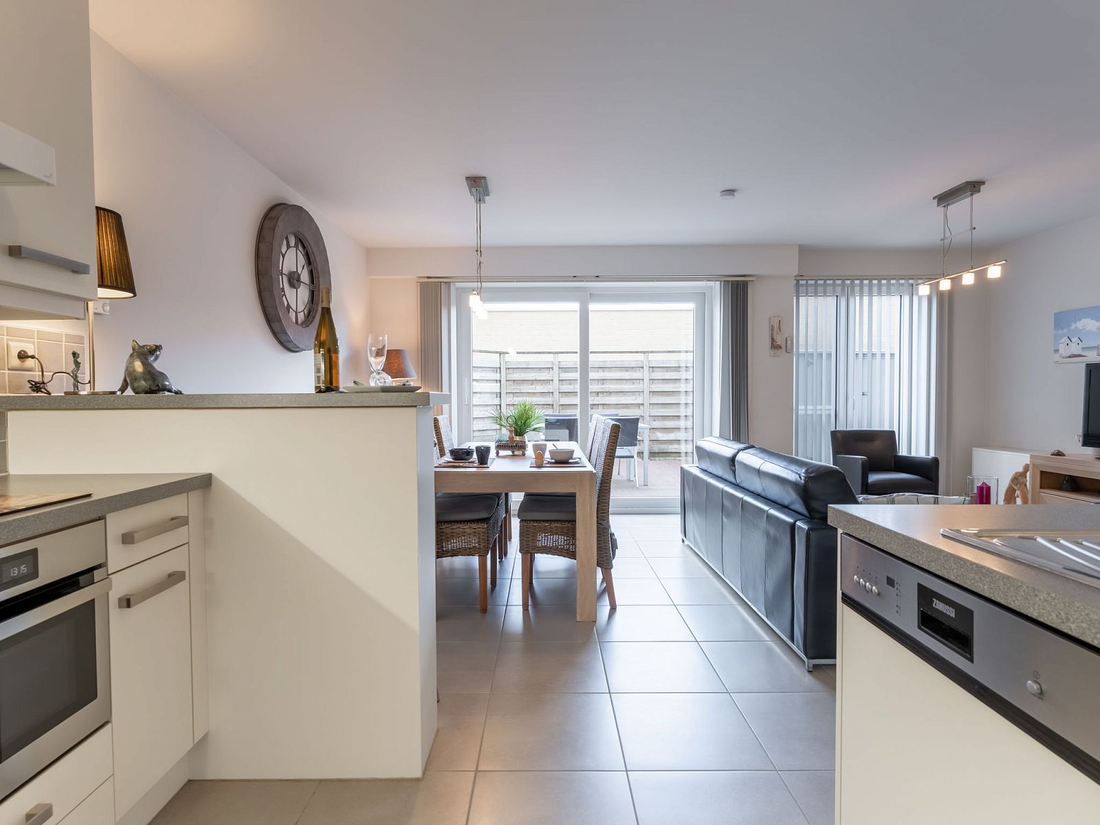 Modern living room and kitchen in Apartment Residentie Zandloper, Bredene, Belgian coast, with spacious sitting area and dining table.