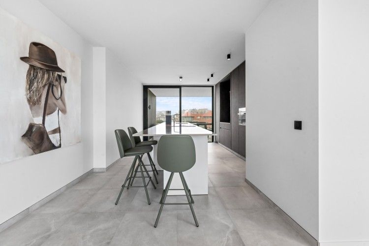 Modern kitchen in Penthouse 'Ter Elst', a luxury apartment in De Panne on the Belgian coast with a view of the city.