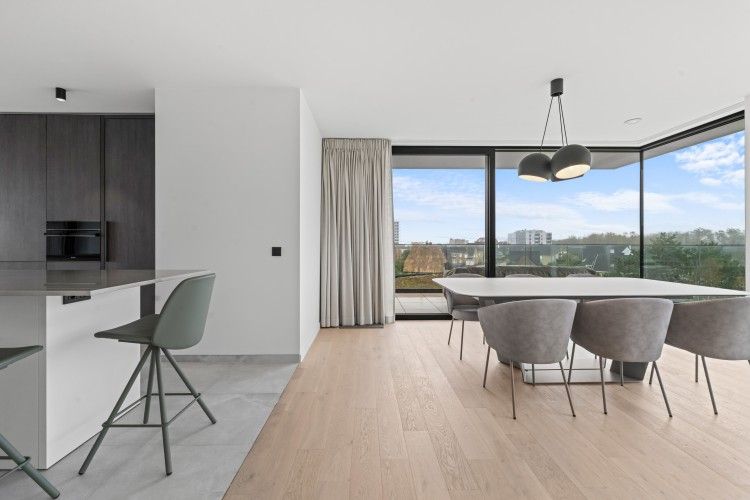 Modern dining room in Penthouse 'Ter Elst', De Panne, Belgian coast, with panoramic views of the surroundings and stylish interior.