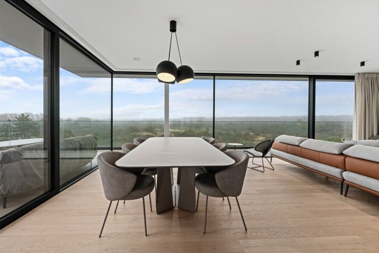 Modern living room of Penthouse 'Ter Elst' in De Panne on the Belgian coast, with panoramic views and stylish interior.