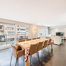Spacious dining and living room of vacation home Brit First in Koksijde, West Flanders, with modern interior and city views.