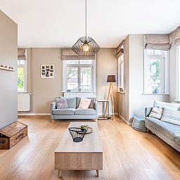 Stylish living room in vacation home Au Coin, Koksijde, West Flanders. Comfortable sitting area with lots of natural light and modern furnishings.