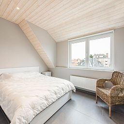 Cozy bedroom in vacation home La Vachequirit, Koksijde, West Flanders, with city views and lots of natural light.