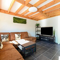 Gemuetliches Wohnzimmer des Ferienhauses Westhinder II H53 in Koksijde, Belgien, mit bequemer Sitzecke und moderner Einrichtung.