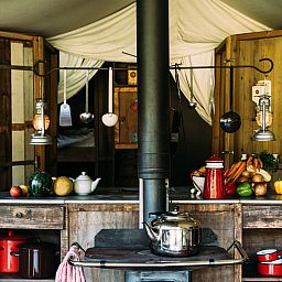 Cozy kitchen of Tent House with hot private shower in Torhout, West Flanders, Belgium, with rustic charm and modern conveniences.