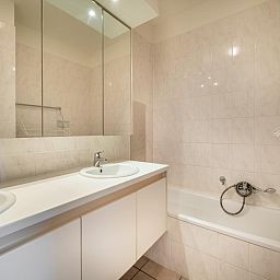 Moderne badkamer in vakantiehuis Cat Tweede, Sint-Idesbald, West-Vlaanderen met stijlvolle wastafel en ruime spiegel.