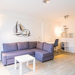 Gemuetliches Wohnzimmer in Scholekster - 0004, Ferienhaus in Middelkerke, Westflandern, mit moderner Einrichtung und einer gemuetlichen Sitzecke.