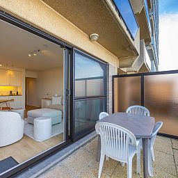 Modernes Wohnzimmer des Ferienhauses "Oasis II - 0002" in Middelkerke, Westflandern, mit stilvoller Kueche und gemuetlicher Sitzecke.