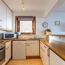 Moderne Kueche im Ferienhaus Dunekant - 0203 + park.6 in Middelkerke, Westflandern, mit Holzarbeitsplatte und reichlich Stauraum.