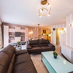 Geraeumiges Wohnzimmer im Ferienhaus Franklin - 0101, Middelkerke, Westflandern. Gemuetliche Sitzecke mit modernen Moebeln und viel Licht.