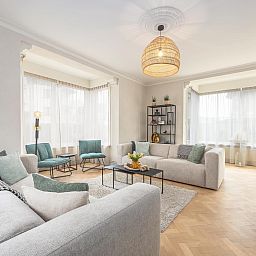 Stijlvolle woonkamer van vakantiehuis Maison Edith in Westende, West-Vlaanderen, Belgie met ruime zithoek en moderne inrichting.