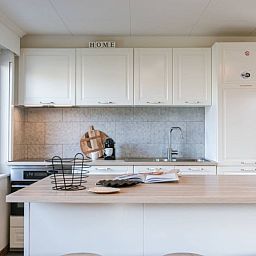 Stylish kitchen with island in Maison du coeur, vacation home in Oostduinkerke, West Flanders.