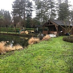 Rustikales Chalet Au Repeau an einem Teich in Moerzeke, Ostflandern, umgeben von viel Gruen.