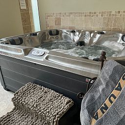 Relax in the luxurious Jacuzzi at Holiday Home Einzigartiger Wellness-Bauernhof in Wichelen, East Flanders, a perfect wellness experience.