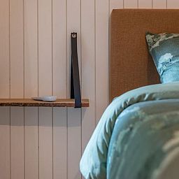 Attractive bedroom in Cottage in Merksplas, vacation home in Antwerp, with comfortable bed and rustic details.