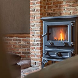 Cozy living room with wood stove in Cottage in Merksplas, vacation home in Antwerp, for cozy evenings.