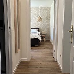 Vacation home in Merksplas, Antwerp, offers an inviting bedroom with a rustic feel for a relaxing stay.