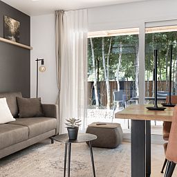 Modern living room in Chalet in Mol, Antwerp, with views of wooded area from the spacious interior.