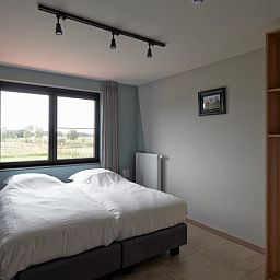 Bedroom in Driehoekshoeve vacation home Kasterlee, Antwerp overlooking the countryside.