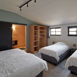 Cozy bedroom with three beds in Driehoekshoeve vacation home, Kasterlee, Antwerp.