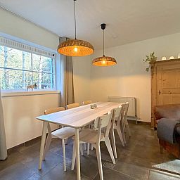 Stylish living room of Lierelodge vacation home in Oud-Turnhout, Antwerp, overlooking the terrace and surrounding nature.
