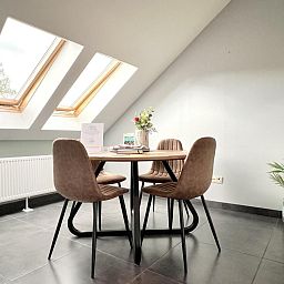 Gezellige eetruimte in 't Vennehuisje, vakantiehuis in Genk, Limburg, Belgie, met veel daglicht en moderne inrichting.