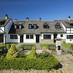 Gezellige woonkamer in Village les Gottales 6-persoons bungalow, Trois-Ponts, Ardennen, met houten balken en knusse open haard.
