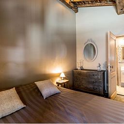 Cozy bedroom in Holiday Home Villa 'Marie France' Wellness, Stavelot, Ardennes, Belgium, with rustic interior and warm lighting.