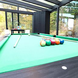 Enjoy relaxation at chalet Agathe in Laforet, Ardennes, with a pool table in the bright indoor space surrounded by nature.