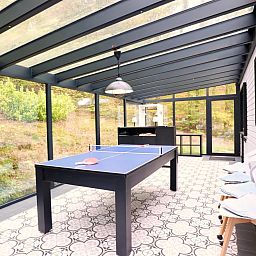 Enjoy relaxation and games at Chalet Agathe, Laforet, Ardennes. Bright indoor space with ping pong table and views of nature.