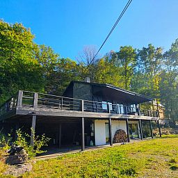 Chalet Agathe in Laforet, Ardennes, Belgium with spacious terrace and surrounded by lush nature.
