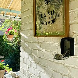 Eingang zum Ferienhaus: An der Flussbiegung, Ferienhaus in Dinant, Ardennen, mit gruener Veranda und inspirierender Wanddekoration.