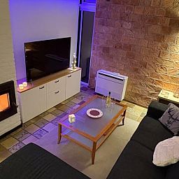 Cozy living room in Cottage in Izier, Ardennes with cozy fireplace and modern decor, ideal for relaxation in Luxembourg, Belgium.