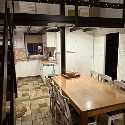 Cozy indoor area of Holiday Home in Izier, Ardennes, with spacious dining table and modern kitchen for a comfortable stay.