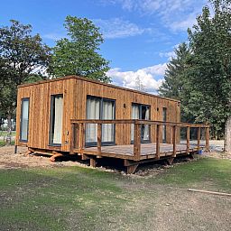 Ecolodge vacation home in Houffalize, Ardennes, Belgium with wooden terrace and surrounded by nature.