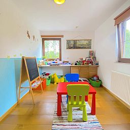 Playroom for children in Holiday Home Wilogne, Houffalize, with colorful interior and toys.