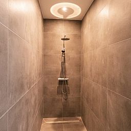 Gezellige woonkamer van Villa Natura, vakantiehuis in La Roche-en-Ardenne, Ardennen, Belgie, met comfortabele zithoek en houten interieur.