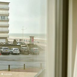 View from the Let's Go Koksijde apartment on the Belgian coast in Koksijde, featuring a sea view and the nearby boardwalk.