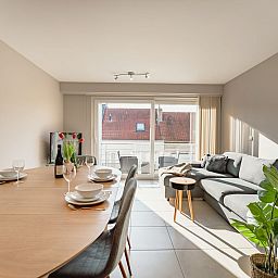 Cozy interior of the Zandloper Apartment with a balcony in Bredene, on the Belgian coast, featuring an inviting terrace and plenty of natural light.