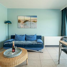 Stylish living room of Apartment Lautrec in Bredene, Belgian coast, with comfortable seating area and modern furnishings.