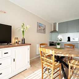 Cozy interior space of Apartment Astrid 62/ 101 in Bredene, Belgian coast, with modern kitchen and sunny dining area.