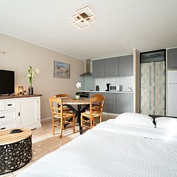 Bright interior space of Apartment Astrid 62/101 in Bredene, Belgian coast, with modern kitchen and cozy dining area.