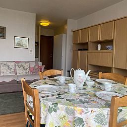 Cozy interior space of Apartment Ref. 702 in Bredene, Belgian coast, complete with dining area and comfortable sitting area.